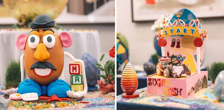 This image features two colorful display pieces. On the left is a toy resembling a potato with detachable features wearing a hat, surrounded by colorful objects. On the right is a model of a vibrant carousel labeled  Sugar Rush  with candy-themed decorations and a whimsical arch marked  Start.  Both are set on tables covered in vibrant, multi-colored candies and decorations, creating a playful and festive atmosphere.