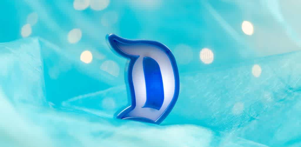 A blue shark fin rests against a soft, flowing light blue background adorned with glimmering bokeh lights. The atmosphere is serene and whimsical, evoking a sense of underwater wonder.