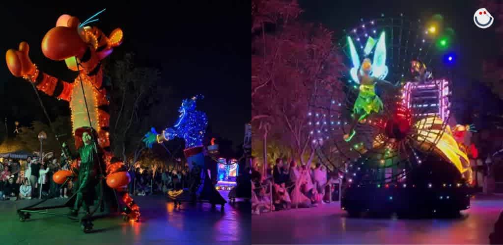 A vibrant nighttime parade features large illuminated floats with characters from a beloved animated series. On the left, a character resembling a tiger and another in blue wave to a crowd. On the right, a character with wings sits atop a glowing float made of circles with colorful lights, creating a magical atmosphere. Spectators line the parade route, enjoying the enchanting display.