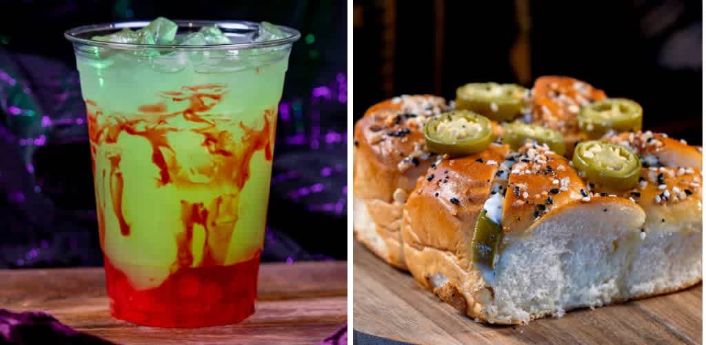 Bright and colorful beverage in a clear cup, featuring layers of red and green with ice cubes on top, sits on the left. On the right, a close-up of soft, golden-brown bread rolls topped with sliced jalapeños and sesame seeds is displayed on a wooden surface. The background is dark and blurred, highlighting the vibrant colors of the food and drink, creating a tempting and refreshing visual.
