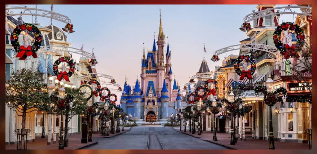A magical theme park street adorned with festive holiday wreaths and decorations leads to a stunning castle with blue spires. The scene captures the enchanting atmosphere of a popular family destination, inviting visitors to experience the joyful celebration and adventure that awaits within the park's attractions.