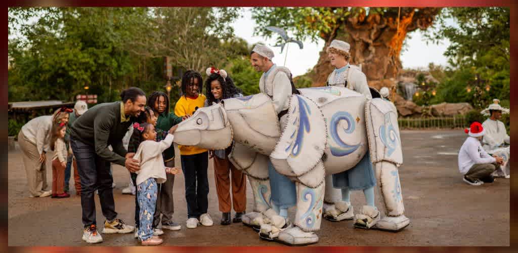 A family with young children interacts joyfully with performers dressed as a polar bear puppet at an amusement park. The scene is set outdoors with lush greenery and a large, intricately carved tree in the background, under warm lighting. The atmosphere is festive, and everyone is smiling, creating a joyful and welcoming environment.
