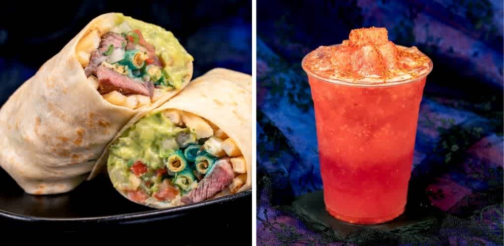 A burrito with meat, cheese, and vegetables beside a red frozen beverage in a cup with a straw on a dark background.