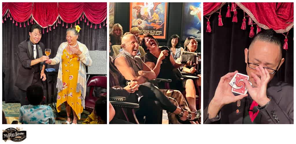 Group of people enjoying a comedy show, laughing and smiling, with a magician performing a card trick on stage.