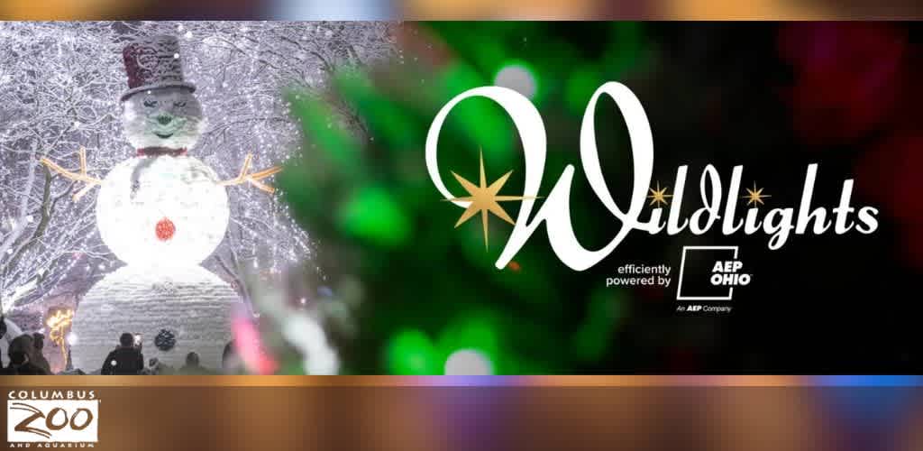 A large festive snowman under illuminated, snow-covered trees.