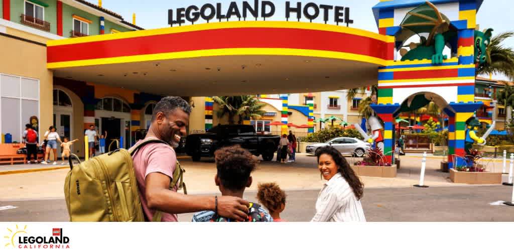 Entrance of the colorful LEGOLAND Hotel with a family smiling in the foreground.