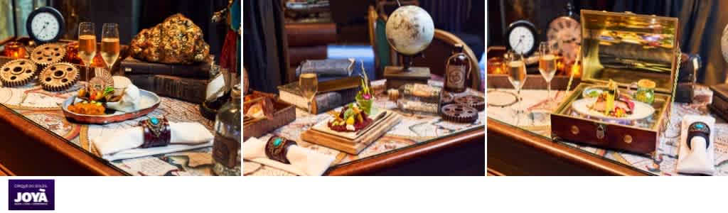 Decorative steampunk-themed tabletop display with gears, vintage clocks, a globe, jewelry, and a treasure chest filled with jewelry and gold coins