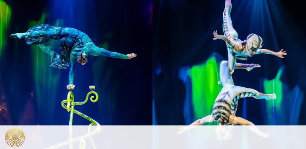 Two performers in colorful tiger and blue costumes balancing on each other's hands during a circus act with vibrant lighting and dark background