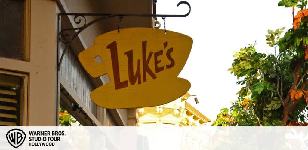 A yellow sign shaped like a coffee cup with 