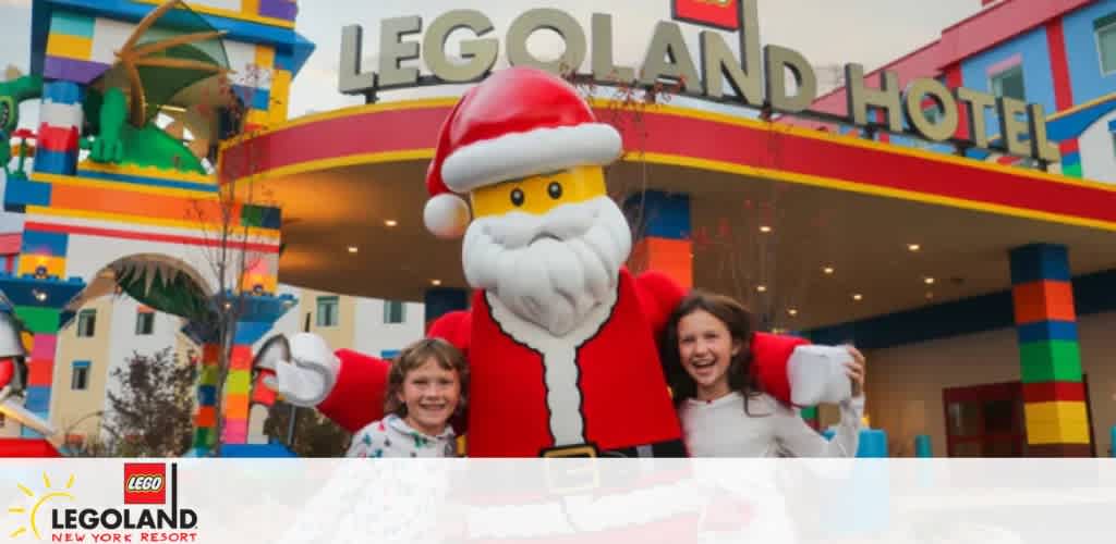 Children posing with a LEGO Santa Claus at the LEGOLAND Hotel entrance.