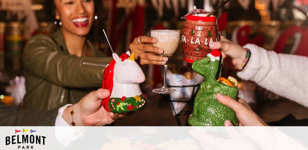 People toasting with festive holiday mugs in various whimsical shapes.