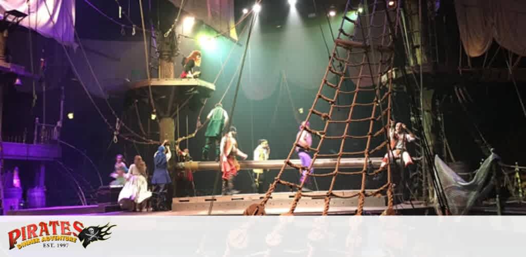 Pirate-themed stage performance with actors in costume on a ship set.