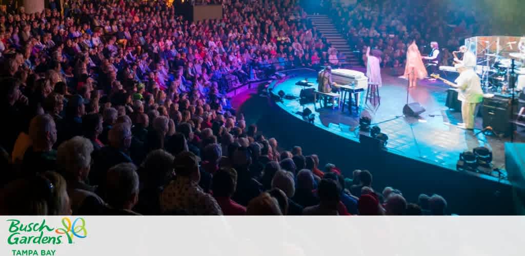 A concert at Busch Gardens Tampa Bay, with a full audience and performers on a circular stage.