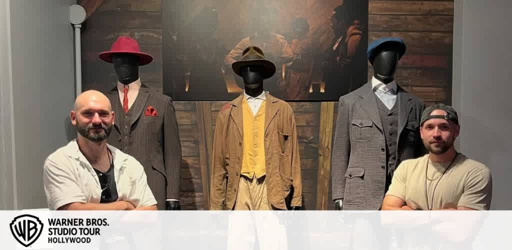 Two men pose with three mannequins dressed in vintage-style suits and hats at Warner Bros. Studio Tour Hollywood.