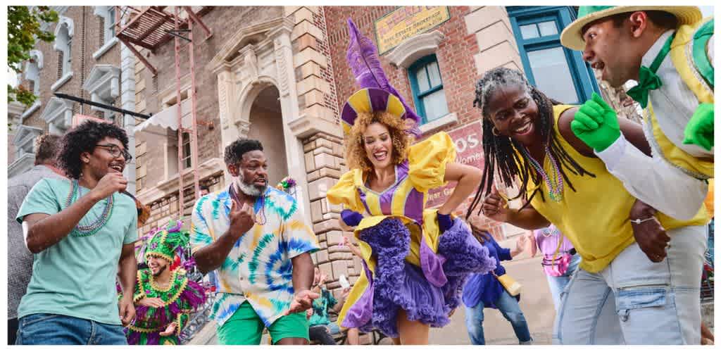 Group of people celebrating in colorful costumes on a city street during a festive event