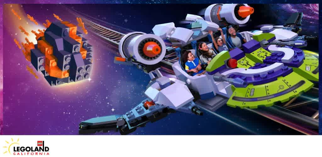 A LEGO-themed spacecraft ride at LEGOLAND California with passengers and a LEGO asteroid in a space backdrop.