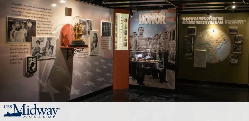 Exhibit showcasing historical photographs, a statue, and information about North Vietnam POW camps during the Vietnam War.
