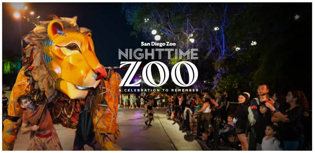 Colorful lion puppet at the San Diego Zoo's Nighttime Zoo event with an audience watching.