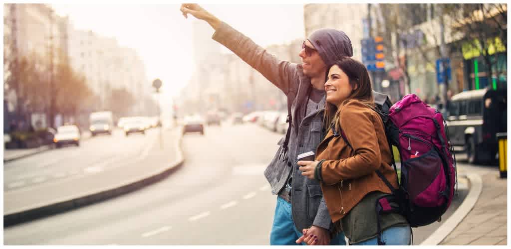 Couple holding hands while exploring the city together on a sunny day.