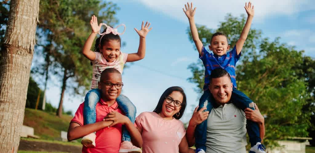 A happy family enjoying summer outdoors in nature.