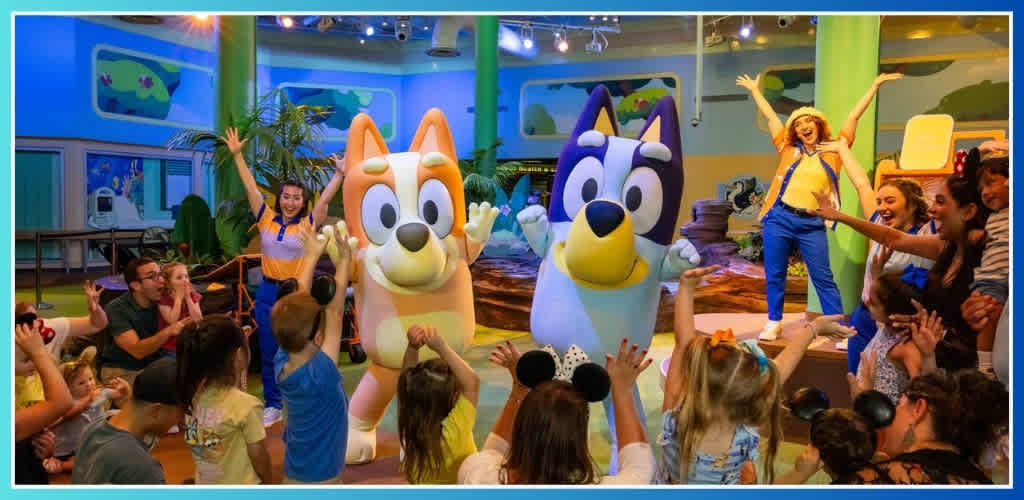 Bluey and Bingo dancing with cast members and kids at Walt Disney World Resort.