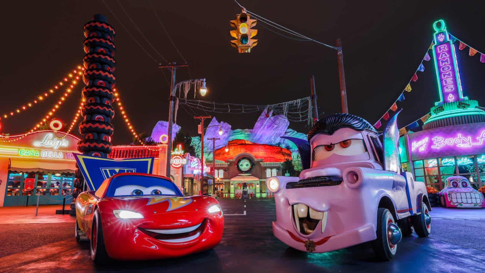 Disneyland's illuminated water fountains create a vibrant display against the night sky.