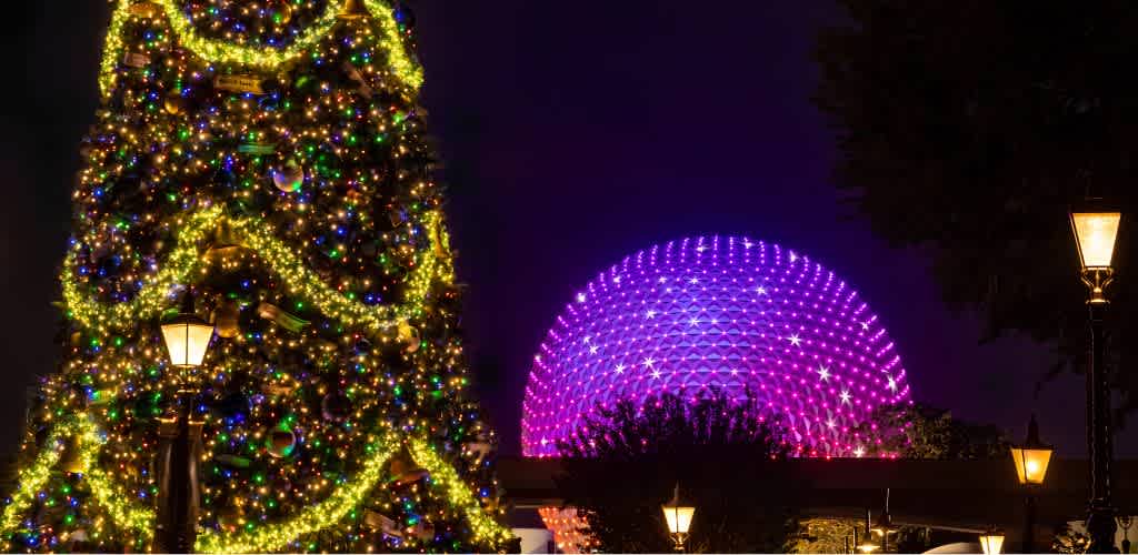A decorated Christmas tree with multicolored lights and yellow ribbons next to illuminated vintage street lamps, with a glowing pink geodesic sphere in the background at night
