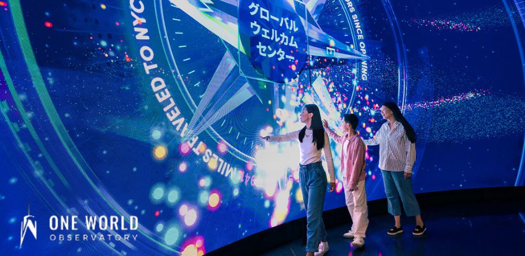 Image of a spacious, modern space exhibition with purple and blue lighting. The center features a large space capsule exhibit with informative displays around it. Above, a model of a space shuttle hangs, dominating the room. Various interactive stations and space-related artifacts are scattered throughout the space, inviting a hands-on experience.