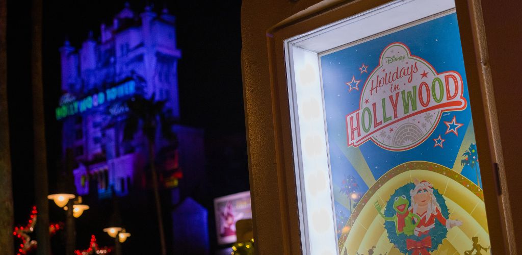 A poster of the Hollywood sign is prominently displayed in front of a building, showcasing iconic Los Angeles imagery.