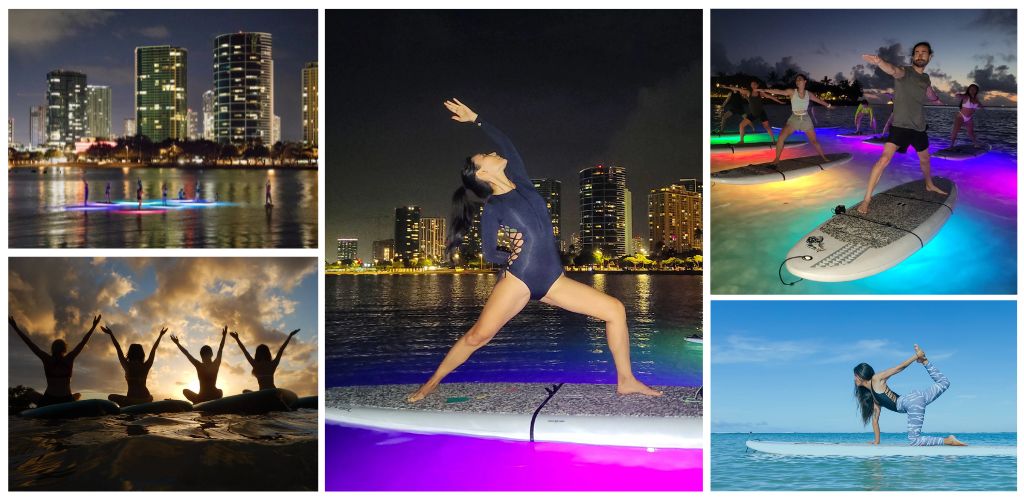 People practicing paddleboarding and yoga on the water during sunset and nighttime with city lights and people enjoying water activities.