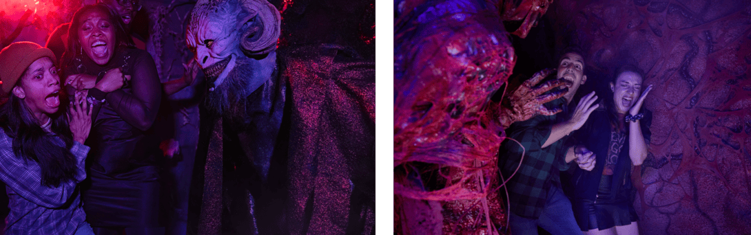 Two groups of people are experiencing a spooky Halloween attraction with colorful lighting and creepy costumes.