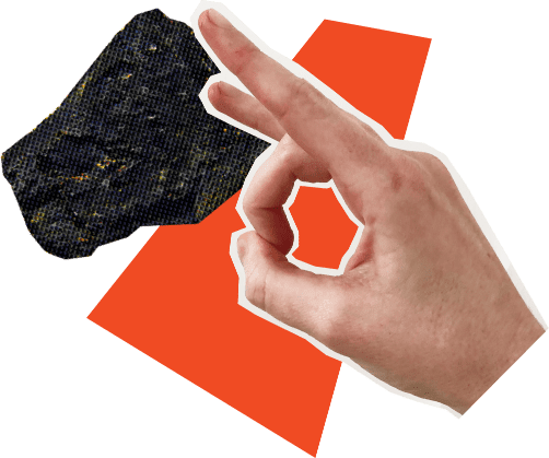 A hand flicking a piece of coal