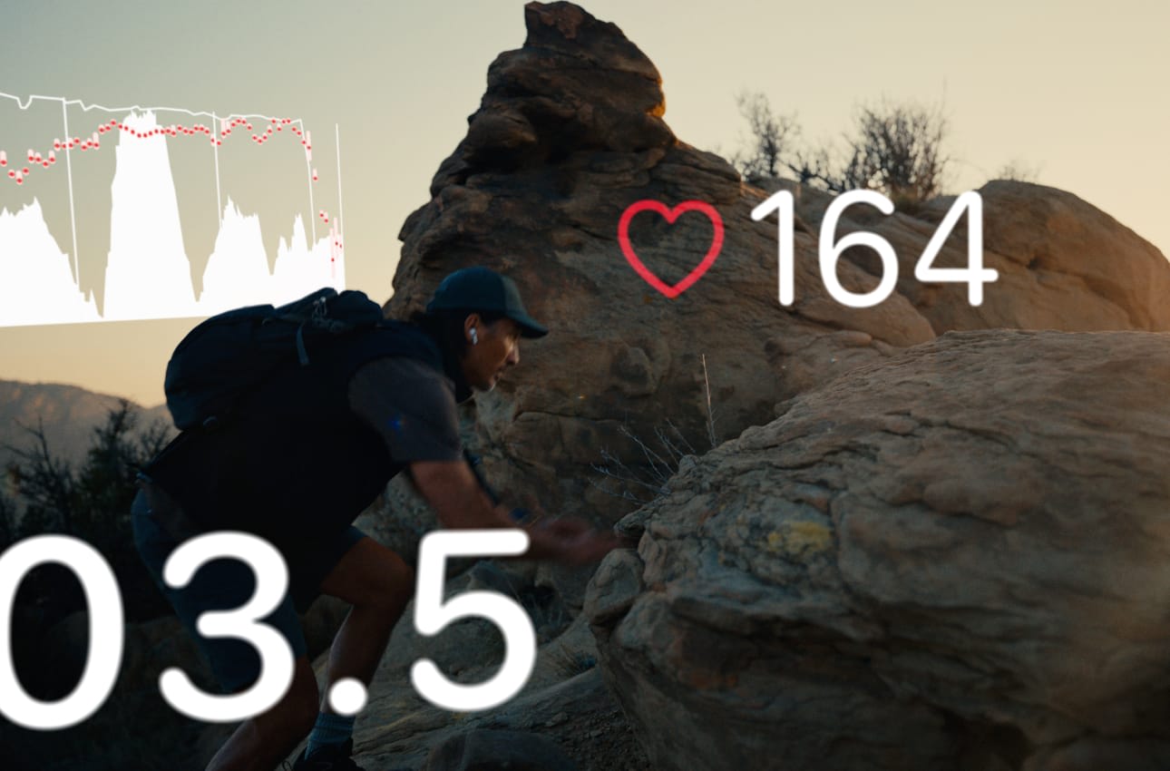 Man climbing rocky terrain outdoors at sunset