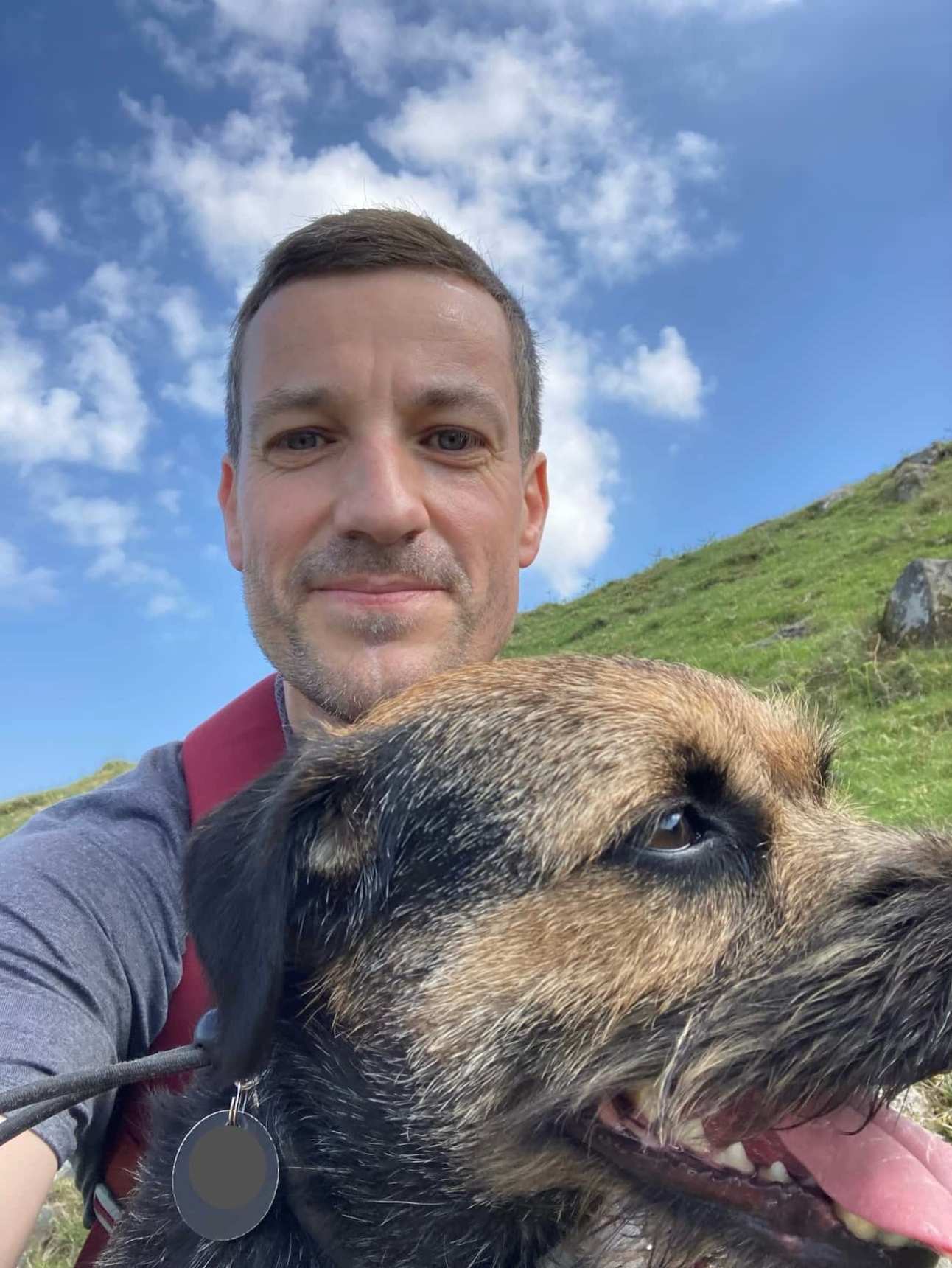 Laurence and Rudy the border terrier take a break while climbing Drumgoyne Hill