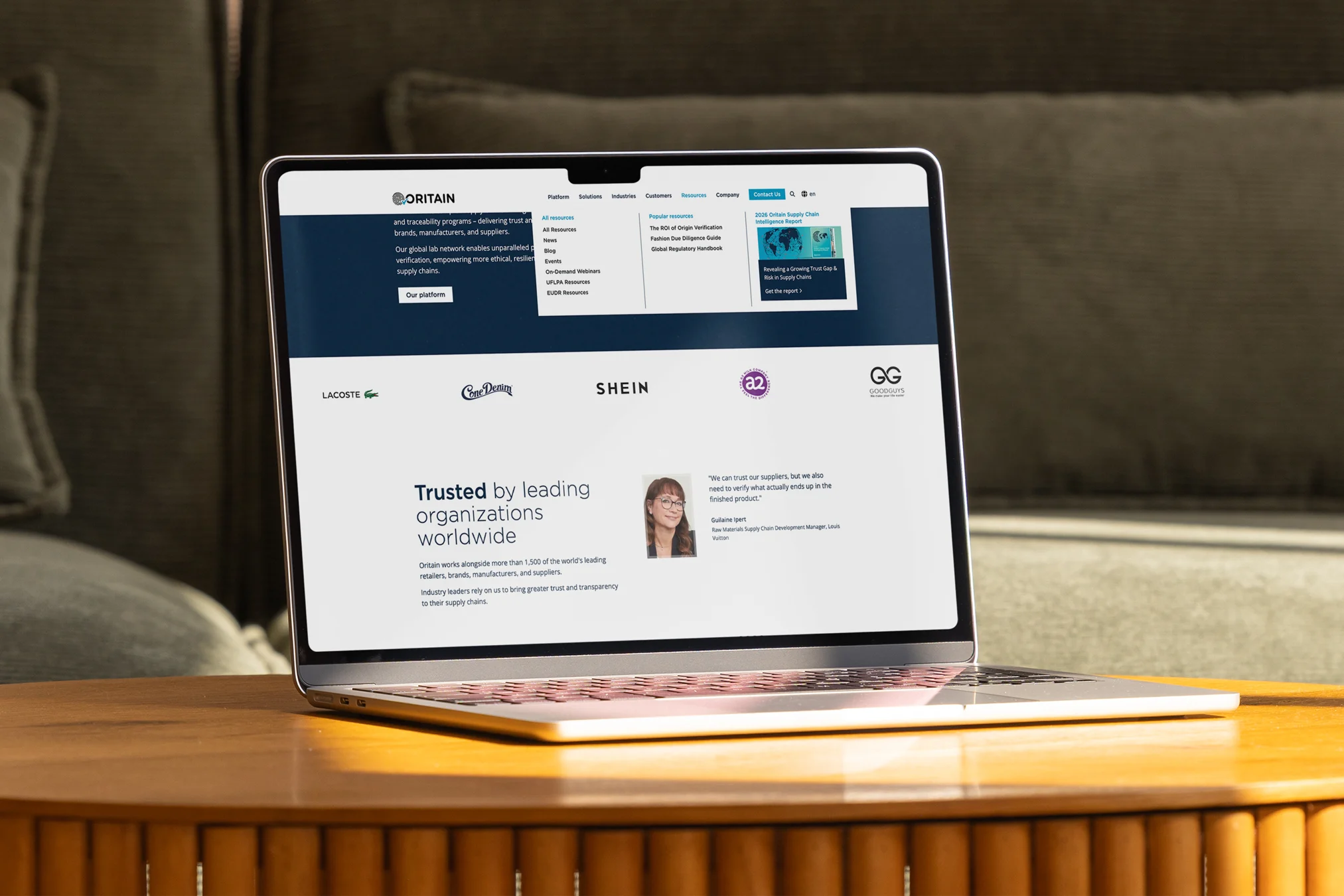 Business website displayed on a laptop resting on a coffee table.