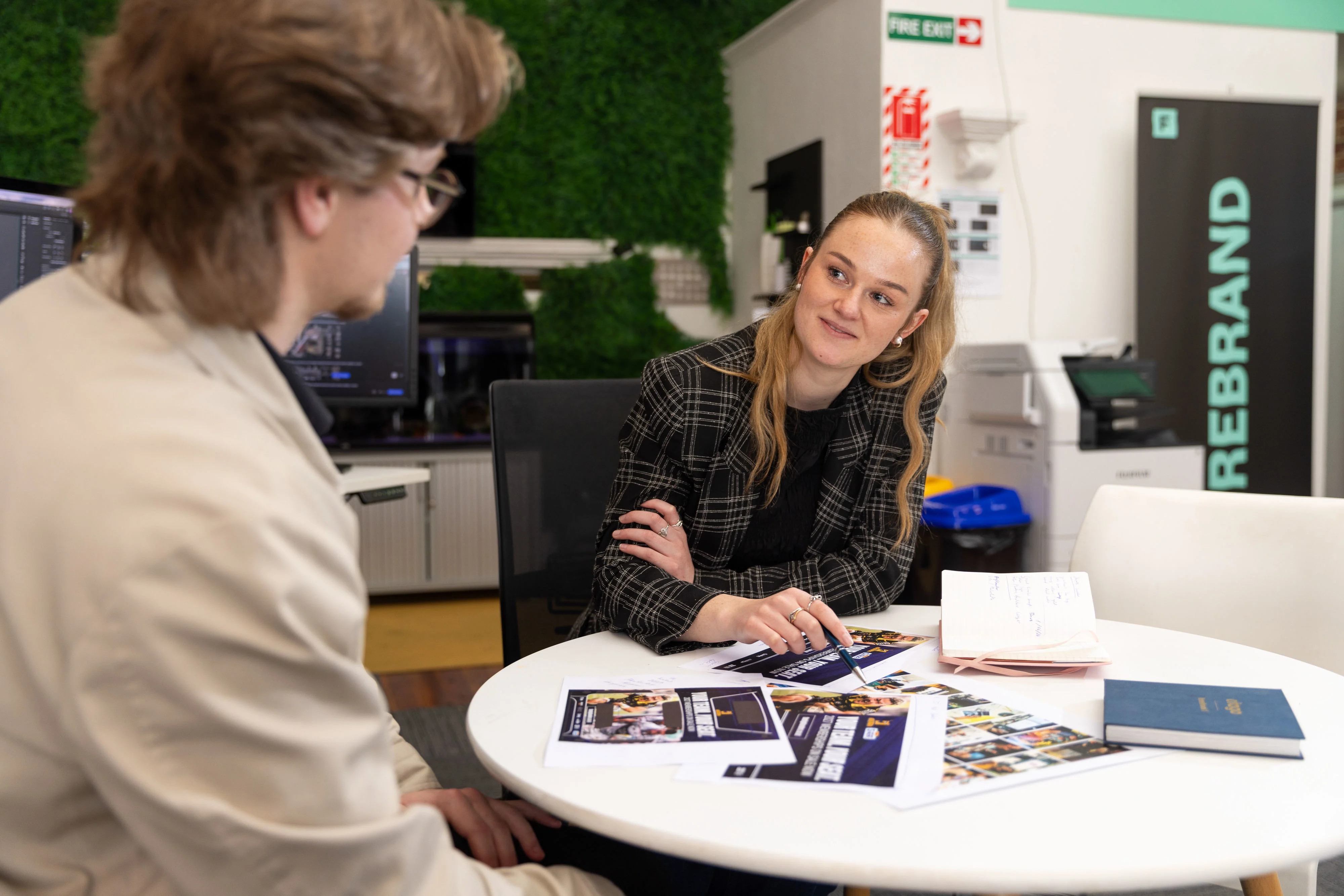 Nick and Trelise sit around a table in the firebrand office.