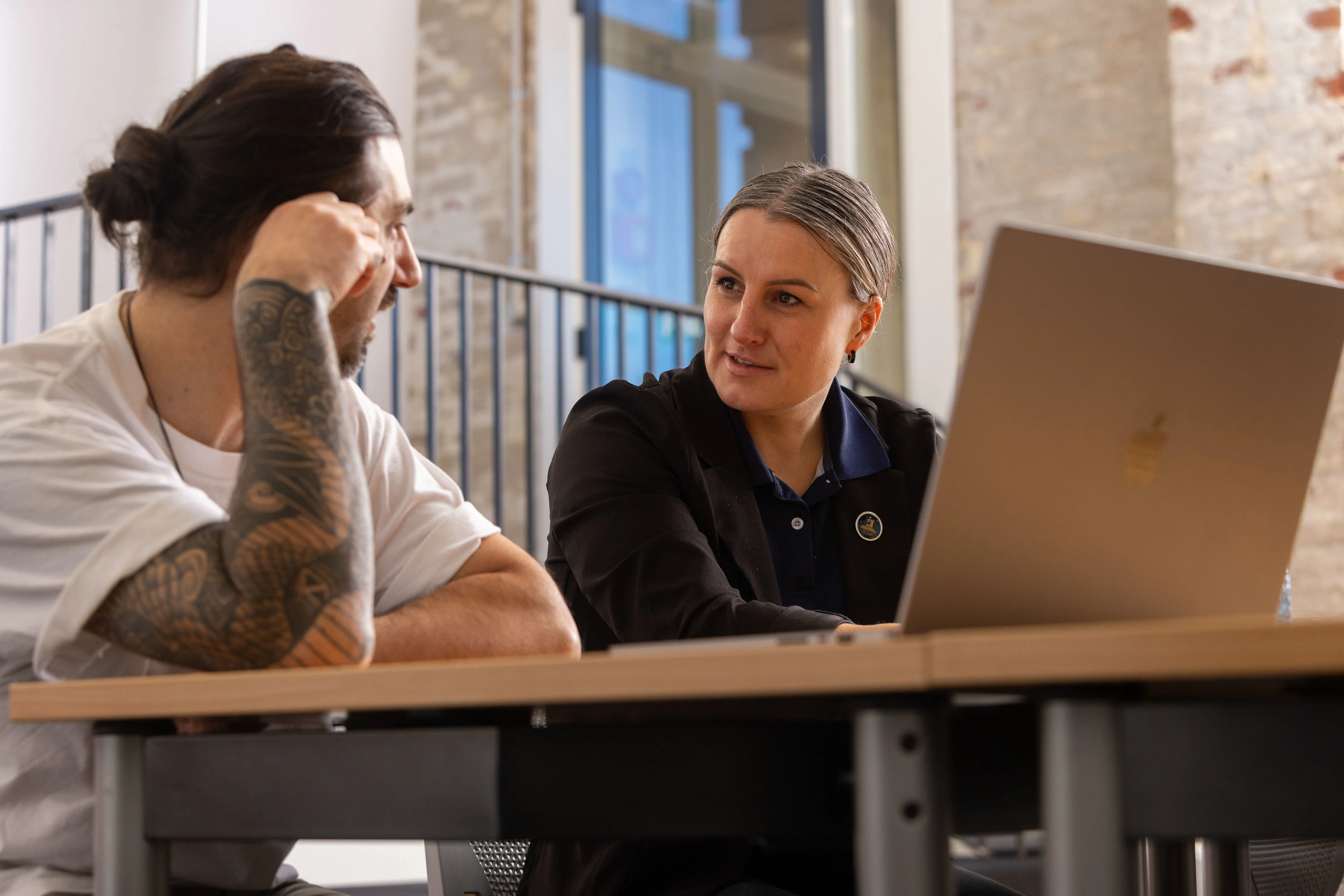 Malcolm with a client at a desk talking at firebrand