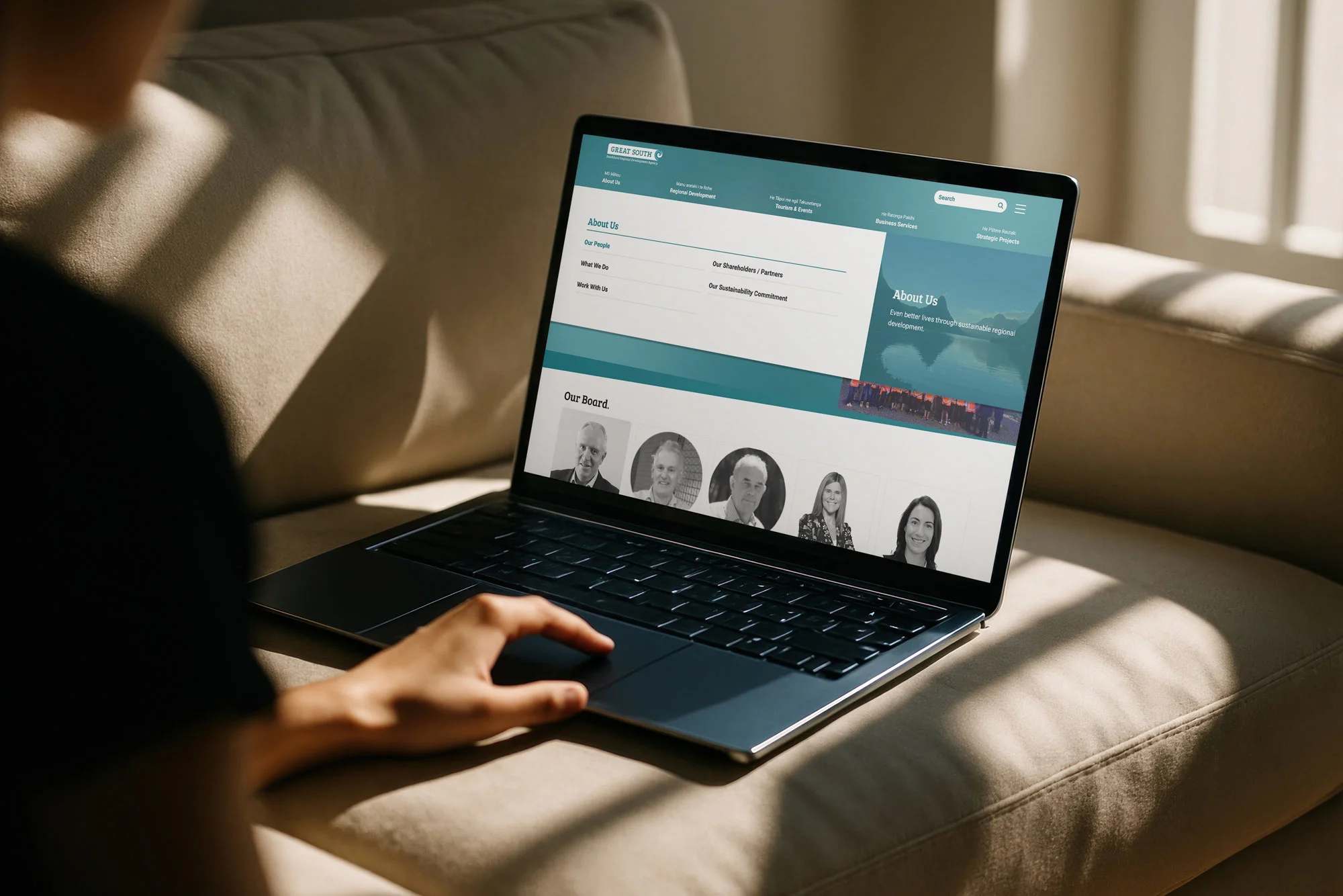Person browsing a team profiles page on a laptop.