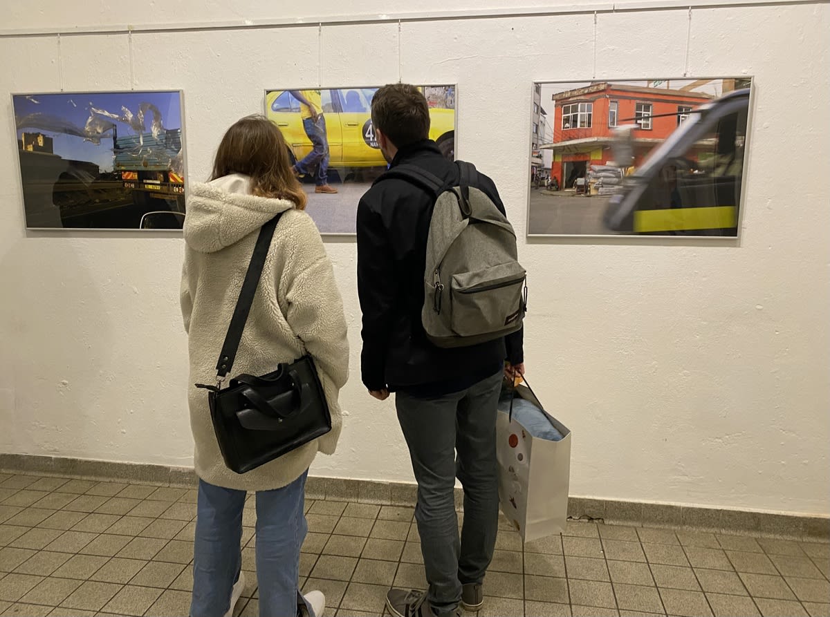 Visitors viewing framed photographs at an exhibition