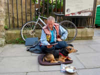 Oxford England 25 August 2017 A homeless sitting at street with his dog