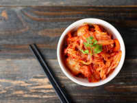 Kimchi and Chopsticks on Wooden Table