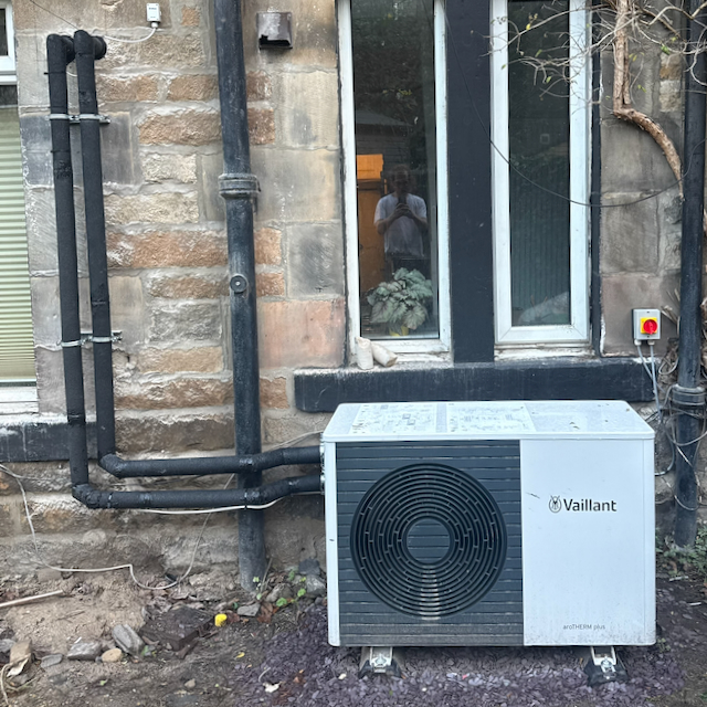 Heat pump unit outside a Victorian tenement close