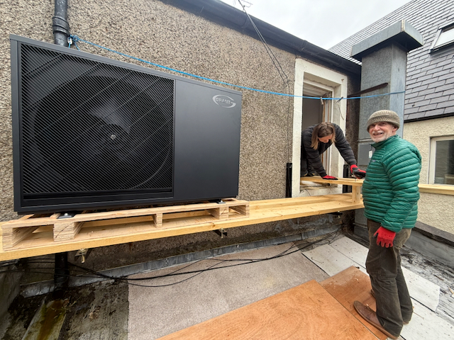 Heat pump installed on a timber platform crossing a roof