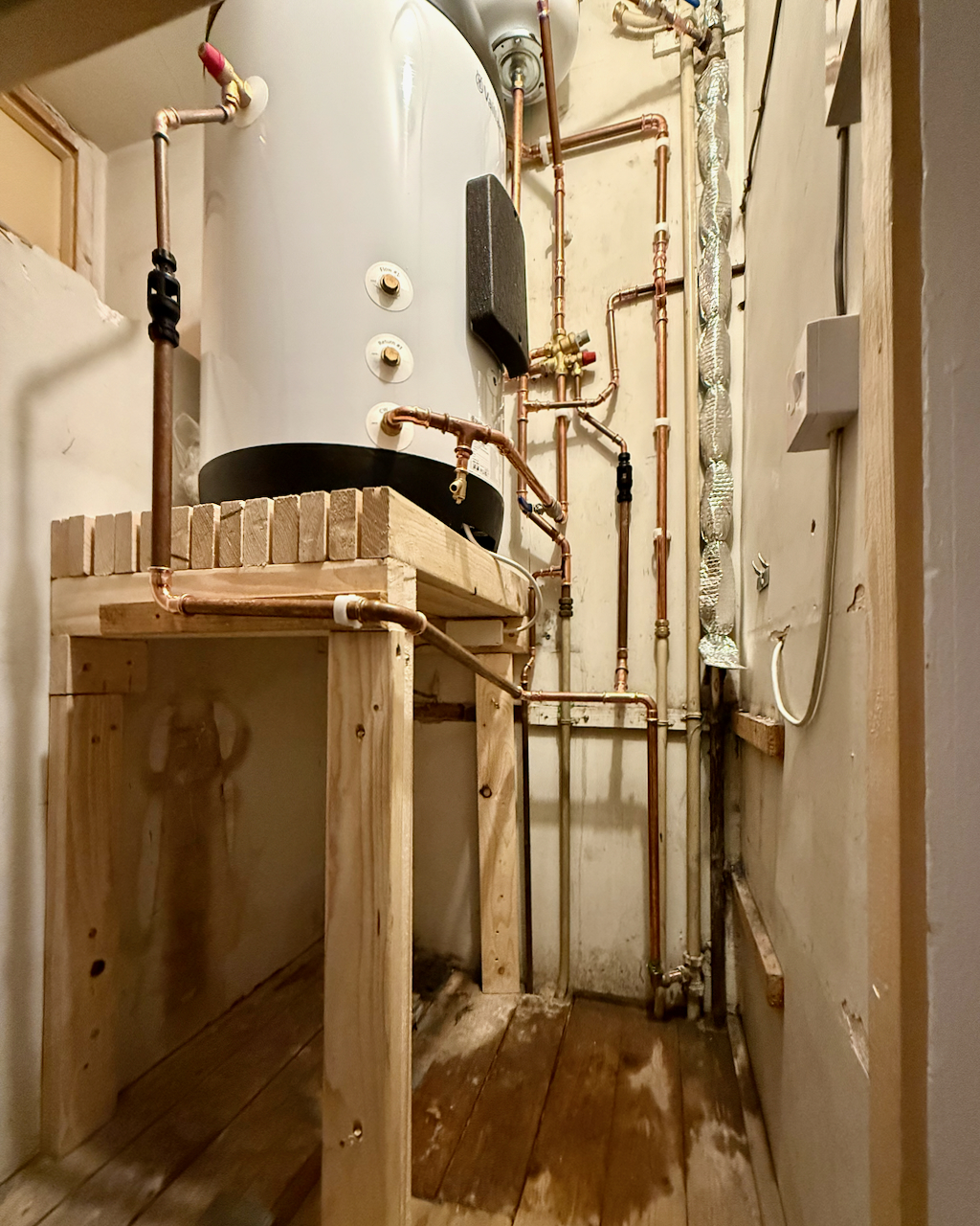 A raised platform built into a cupboard for a cylinder