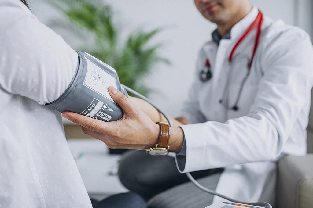 Physician checking a patient’s blood pressure