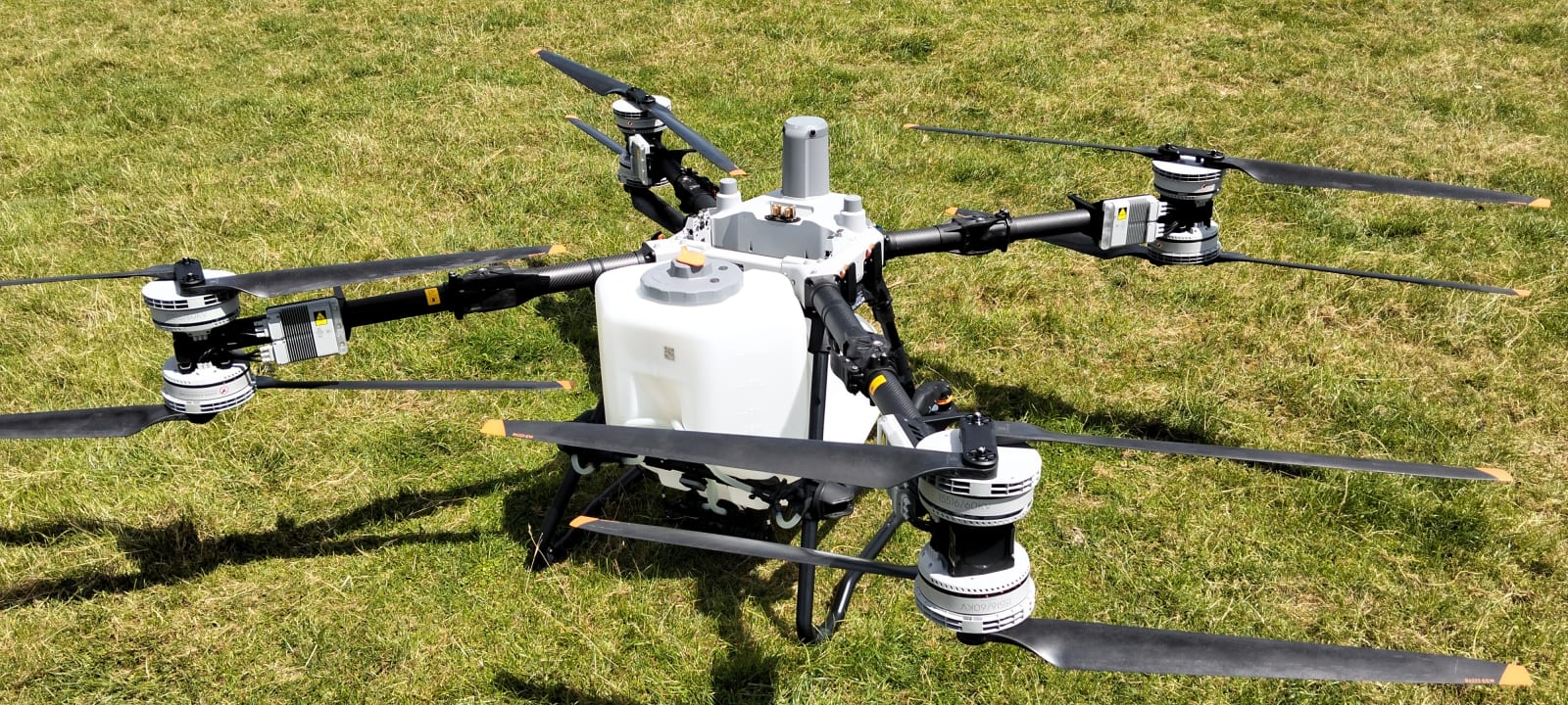 DJI Agras T100 agricultural drone in paddock