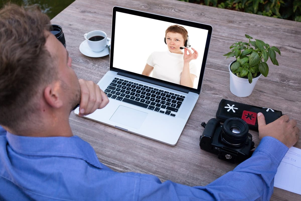 Man video call laptop home