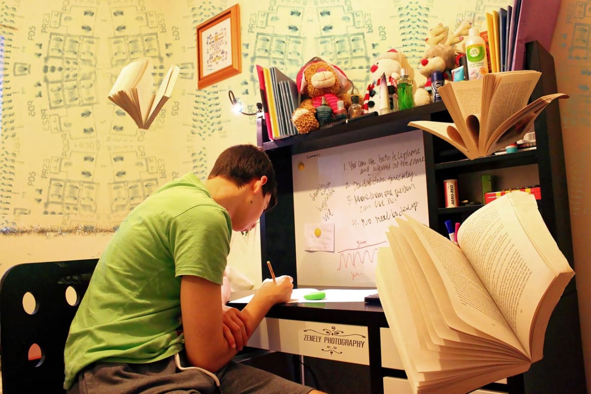 Student writing exam laptop