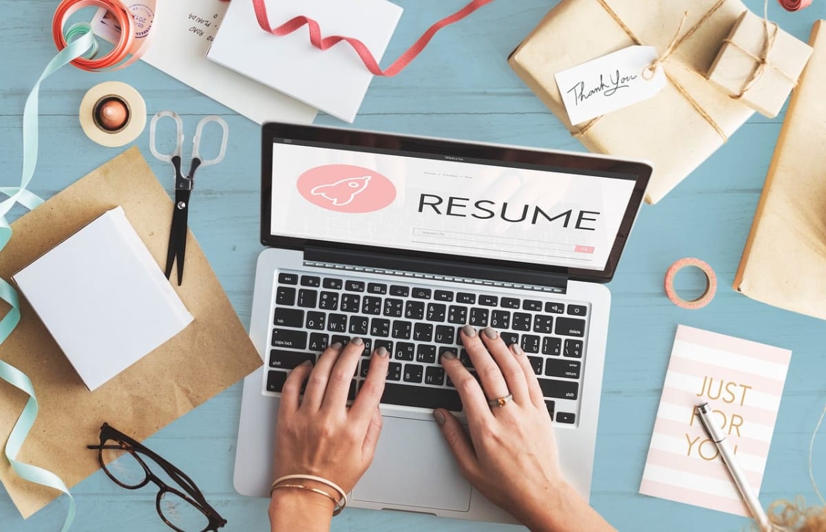 Job seeker writing cv laptop