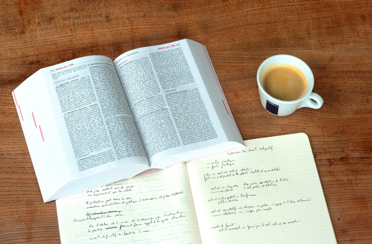 Student reading documents desk